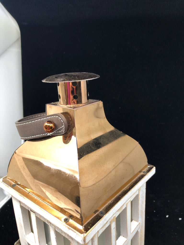 WHITE DISTRESSED LANTERN W/ COPPER ROOF LEATHER HANDLE.