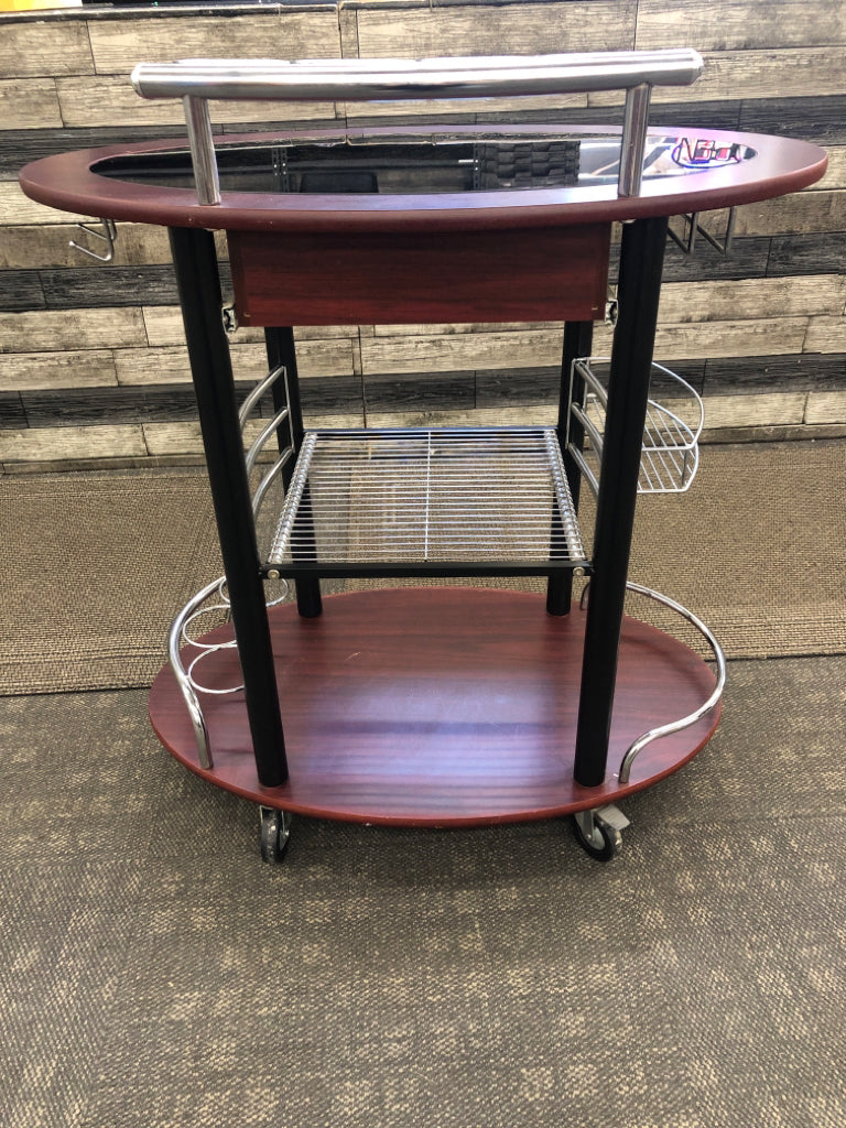 DK WOOD OVAL ROLLING BAR CART W/BLACK GLASS TOP.
