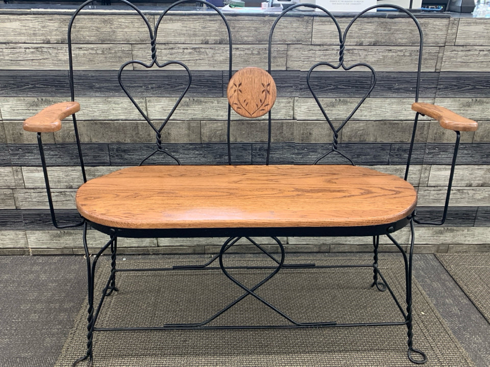 WOOD BENCH W/BLACK WIRE HEART BACK REST.