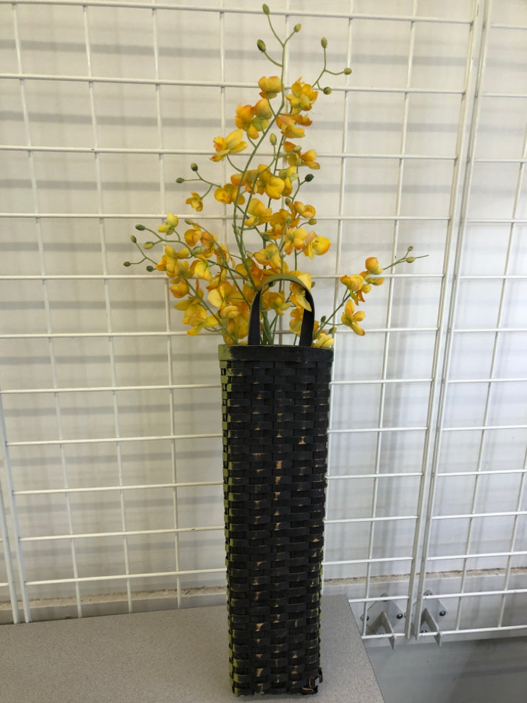 FAUX YELLOW FLOWERS IN GREEN WOVEN BASKET WALL HANGING.