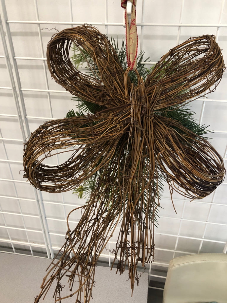 BOW SHAPED WREATH WITH GREENERY AND STARS.