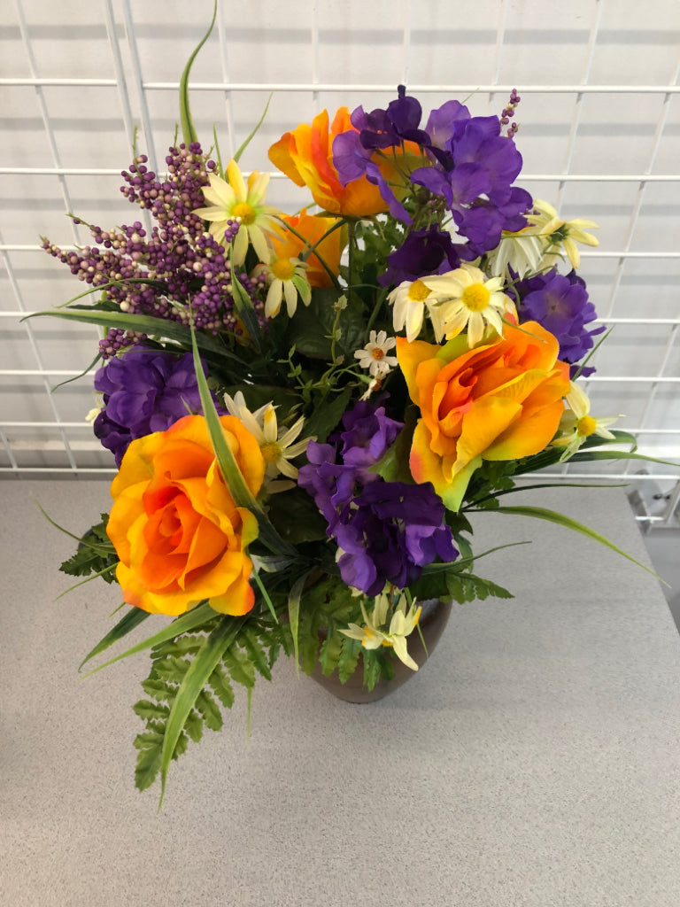 PURPLE/ORANGE FLOWERS IN BROWN VASE.