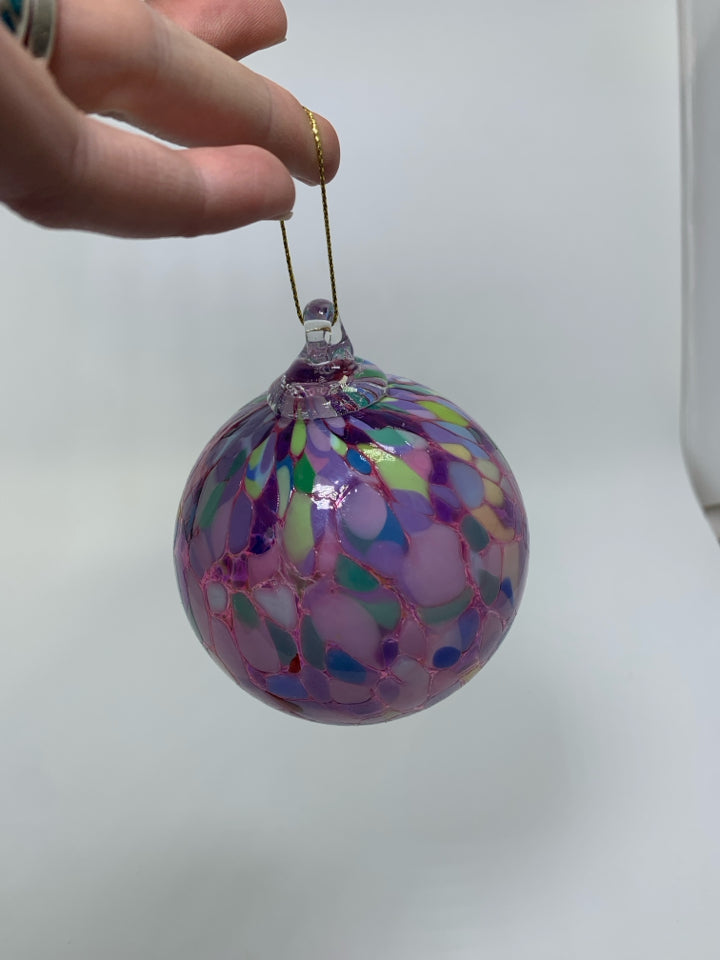 PINK BLOWN GLASS ORNAMENT W/ COLORFUL SPOTS.