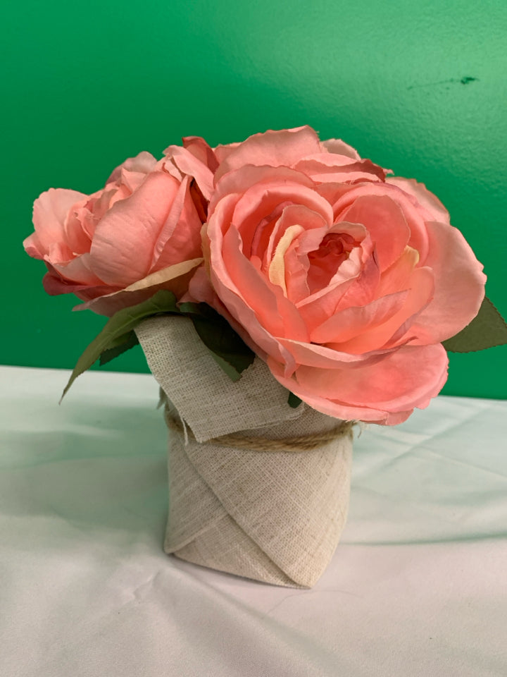 FAUX PINK FLORAL IN BURLAP PLANTER.