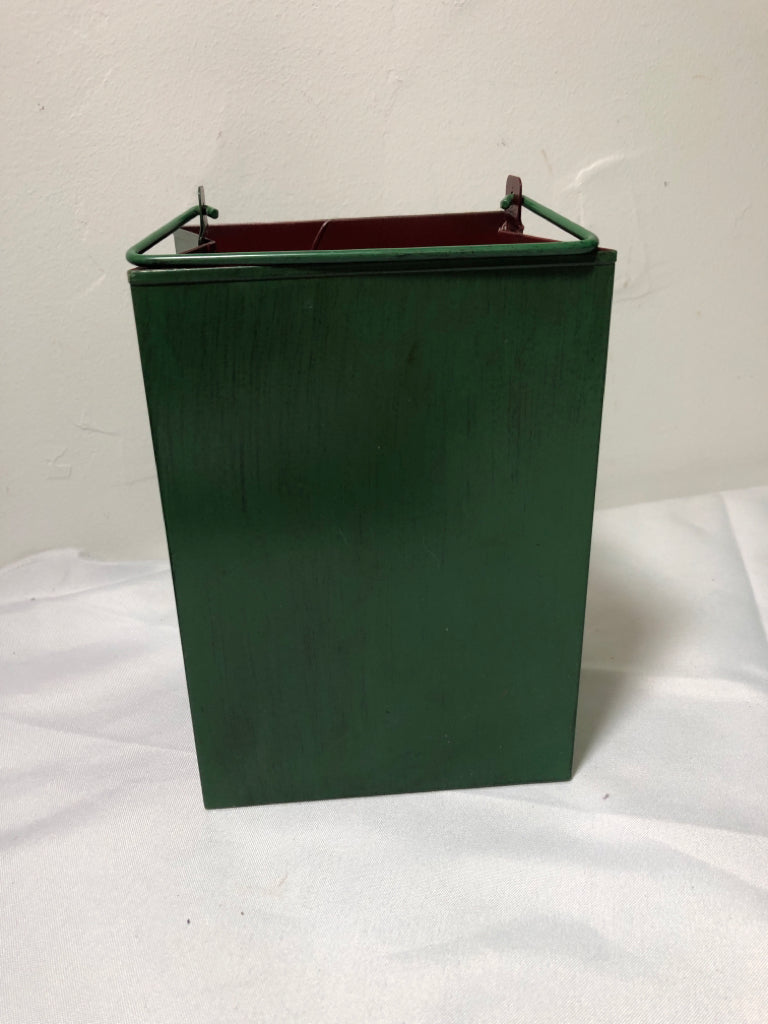 GREEN METAL PIERCED BAG CANDLE HOLDER W HANDLES.