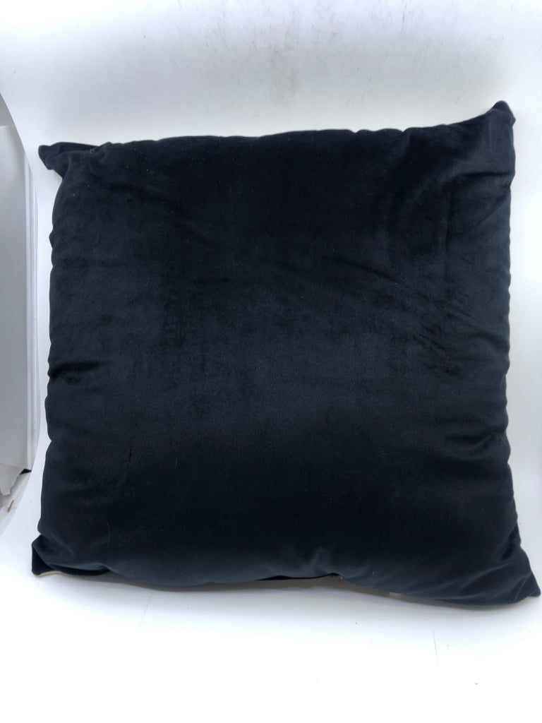 BLACK AND TAN PILLOW.