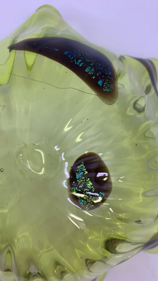 BLOWN LIGHT GREEN GLASS BOWL W/ DARK BROWN SPOTS UNEVEN EDGE.