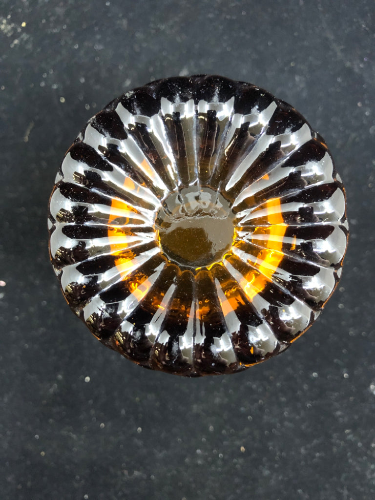AMBER GLASS EMBOSSED TEALIGHT HOLDER.
