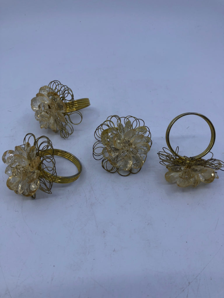 4 GOLD NAPKIN RINGS W/CRYSTAL GEMS.