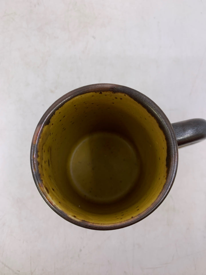 MUSTARD YELLOW POTTERY MUG W/ BROWN FLOWER DESIGN.
