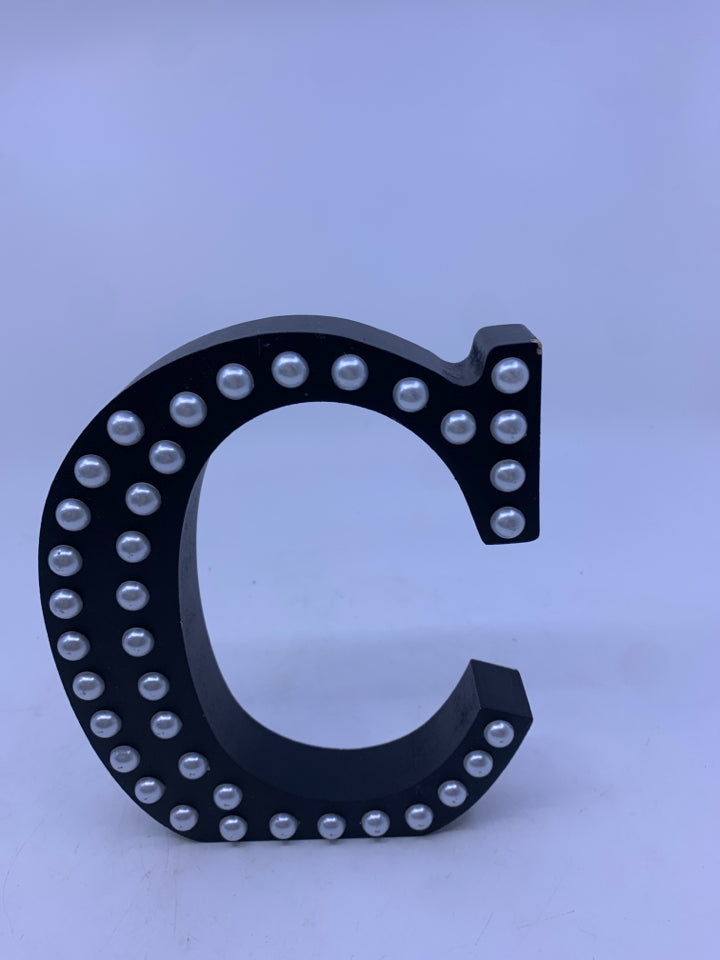 "C" BLACK W PEARLS STANDING SIGN.