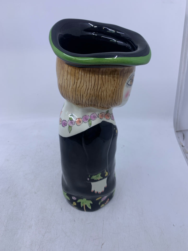 WOMAN SHAPED VASE W/ BLACK DRESS FLOWER NECKLACE.