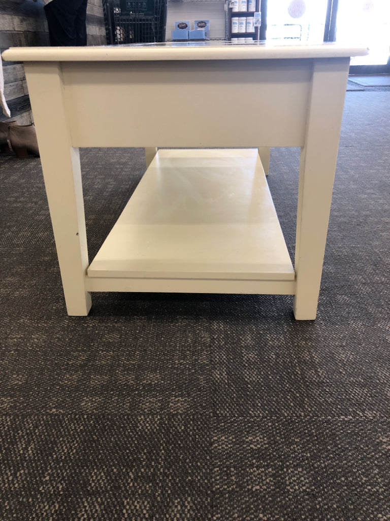 CREAM COFFEE TABLE W GLASS TOP AND 2 DRAWERS.