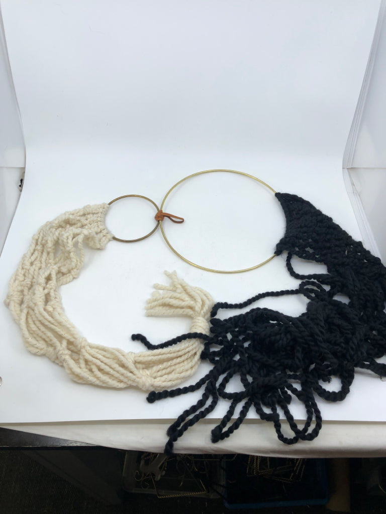 BLACK/WHITE MACRAME WALL HANGING W/ 2 GOLD RINGS.