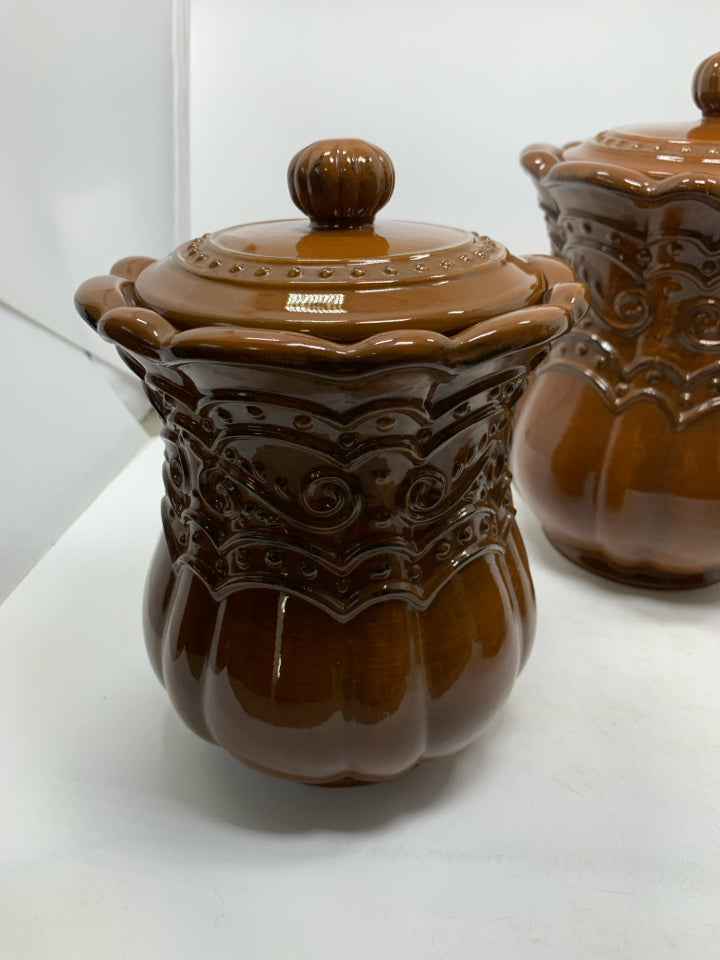 3 LIGHT BROWN SCROLL DETAILED CANISTERS.
