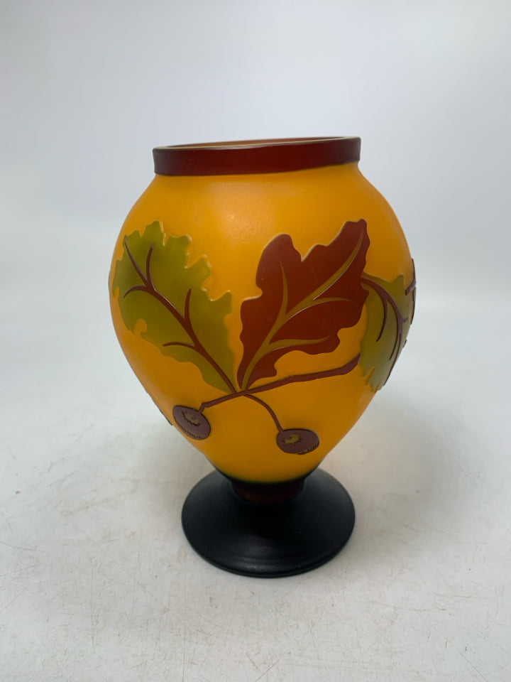 EMBOSSED ORANGE LEAVES/ACORN FOOTED VASE.