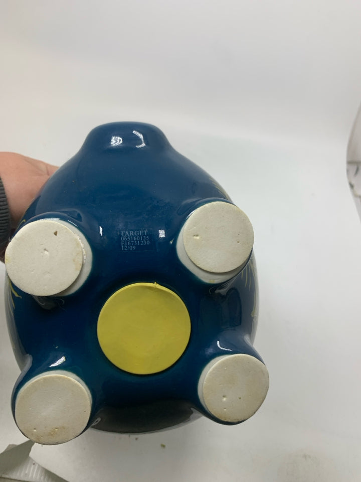 DARK BLUE PIGGY BANK W/ PEACOCK FEATHER DETAILS.