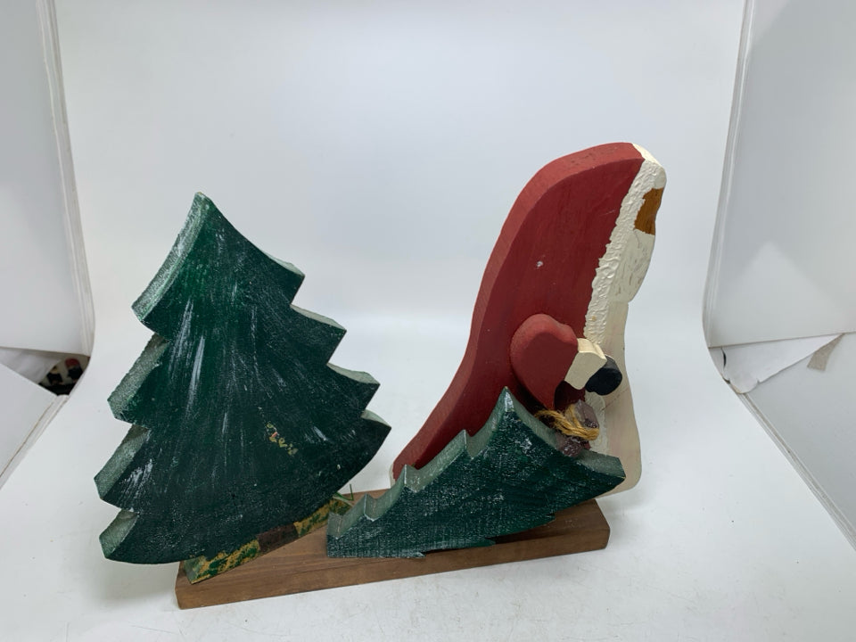PRIMITIVE WOOD SANTA PULLING TREE.