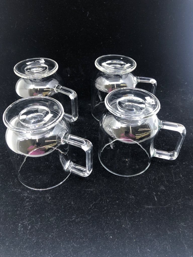 4 FOOTED GLASS MUGS.