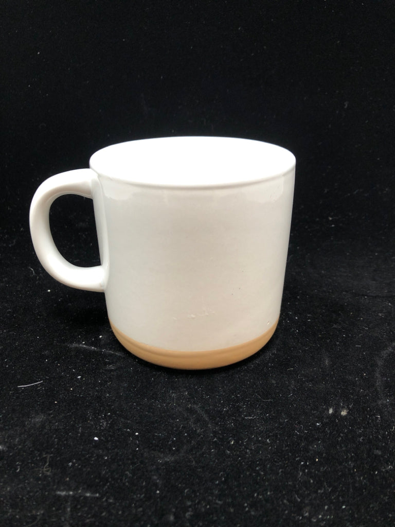 WHITE MUG W/BEIGE BOTTOM.