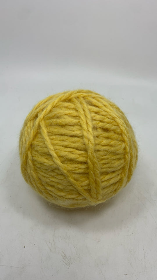 ROUND YELLOW SOFT YARN BALL.