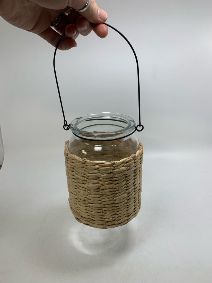 GLASS JAR W/ BASKET WOVEN OUTSIDE LANTERN.
