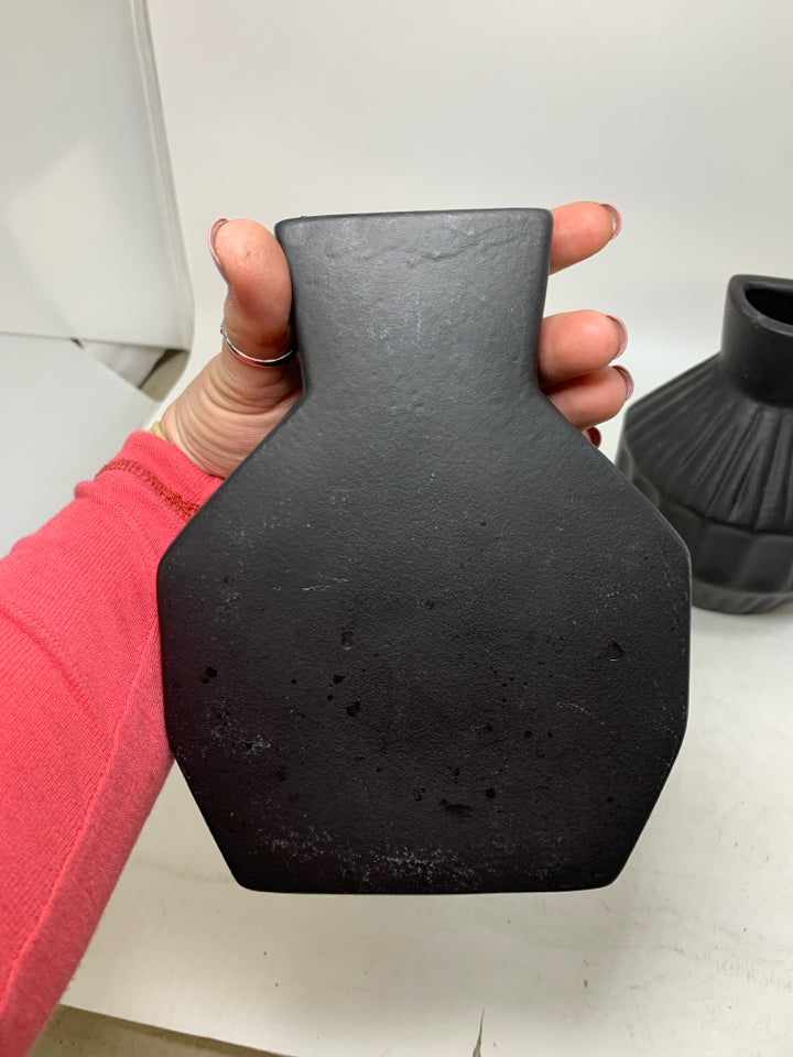 2 BLACK CERAMIC ONE FLAT SIDE VASES.