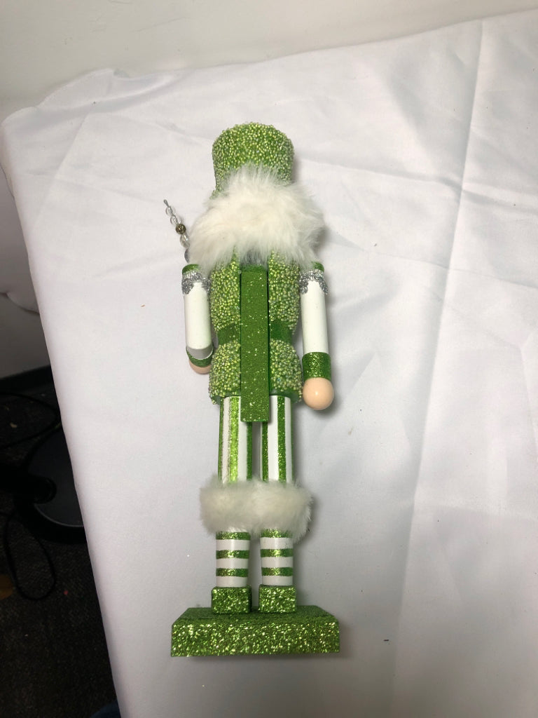 GREEN AND WHITE GLITTER NUT CRACKER.
