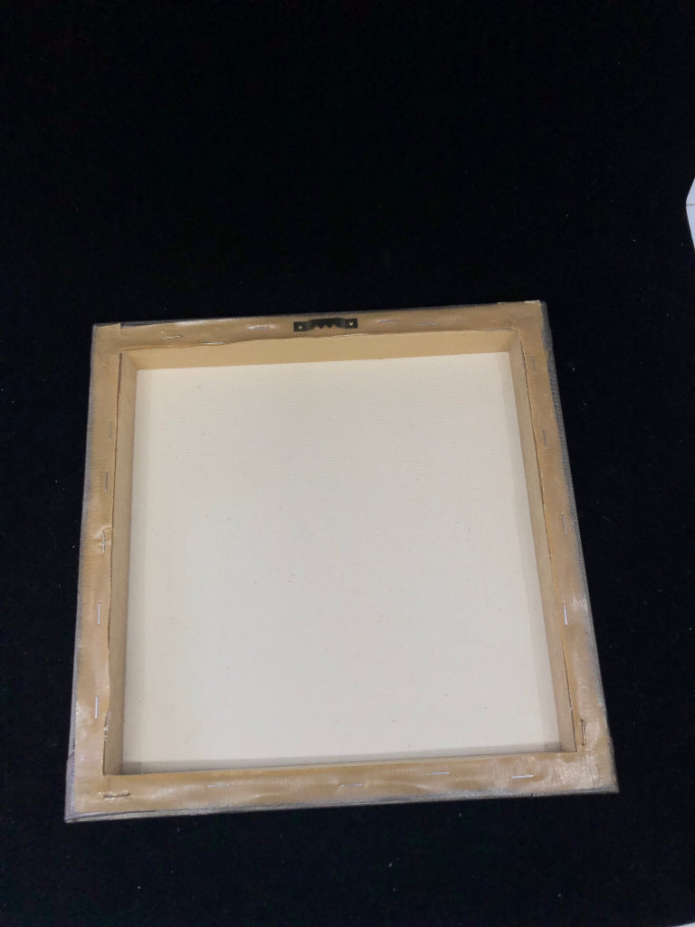 BROWN CANVAS WITH WHITE FLORAL WALL ART.