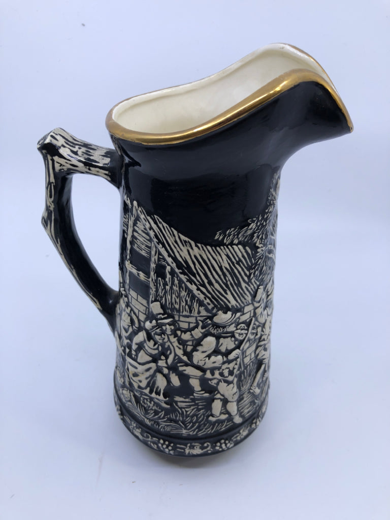 VTG BLACK W EMBOSSED PEOPLE DANCING PITCHER.