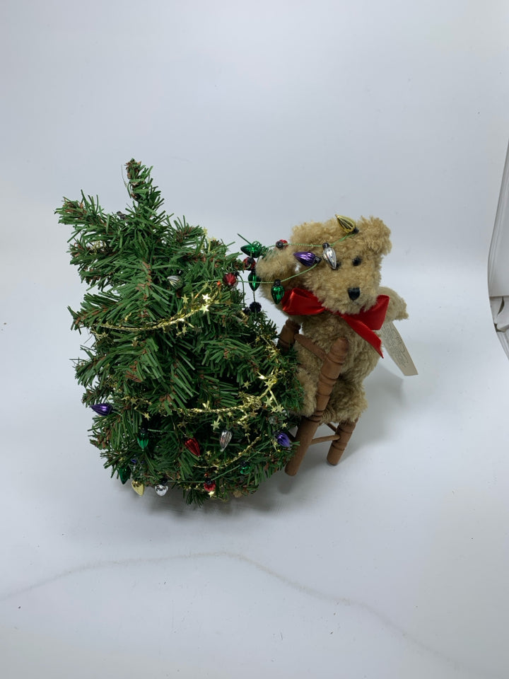 BOYDS BEAR SMALL BEAR PUTTING LIGHT ON TREE STANDING ON CHAIR.