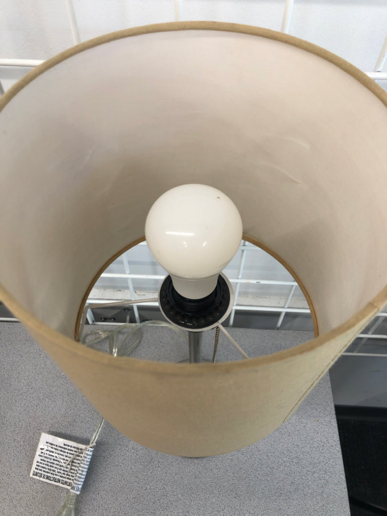 SILVER BASE OUTLET LAMP W/TAN SHADE.