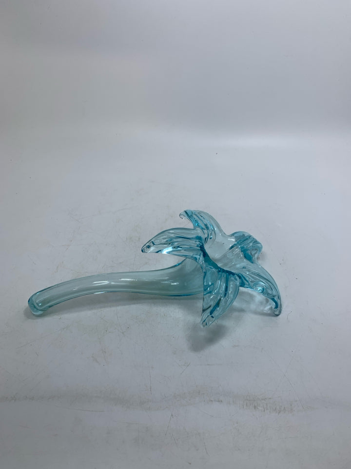 BLOWN GLASS LIGHT BLUE FLOWER LAYING FLAT.
