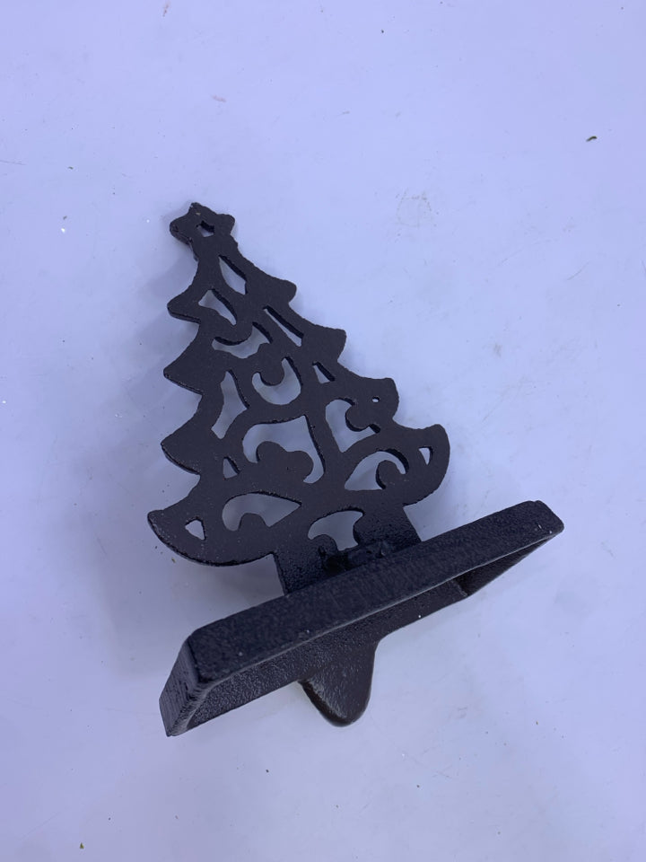 BROWN METAL CUTOUT TREE STOCKING HOLDER.