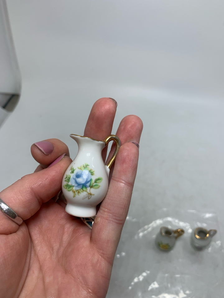 4 MINI PITCHERS W/ ASSORTED FLOWERS IN BAG.