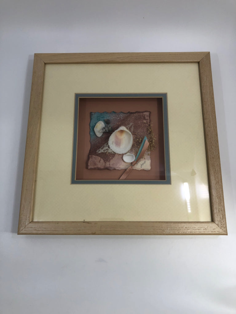 SEASHELL COLLAGE IN SHADOW BOX W/TAN&PINK WOODEN FRAME.