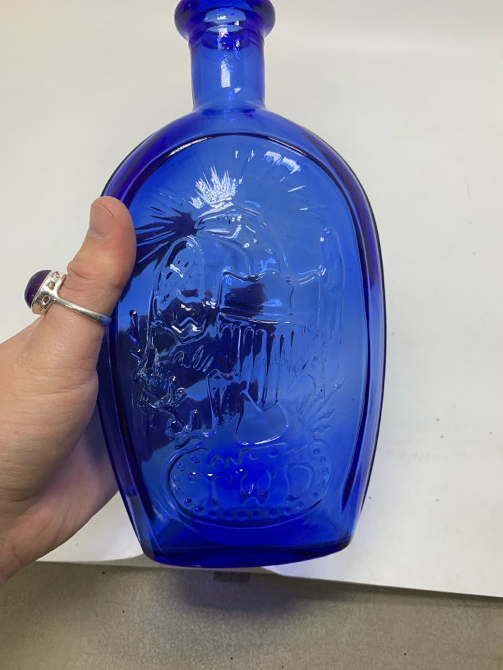 EMBOSSED SHIP BLUE GLASS BOTTLE EMPTY.