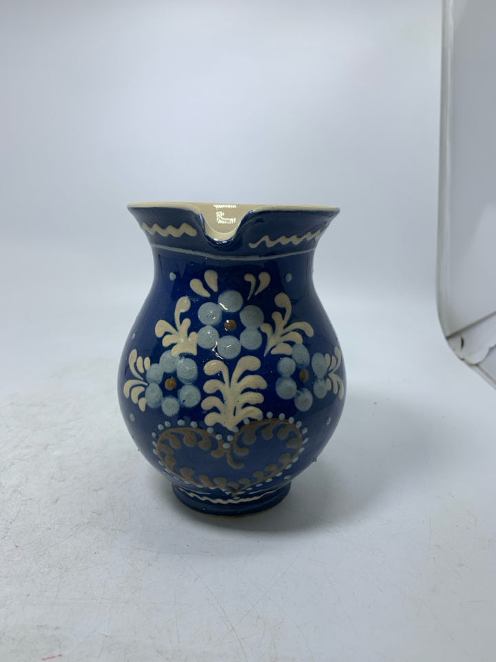 DARK BLUE CREAMER W/ PAINTED FLOWERS.
