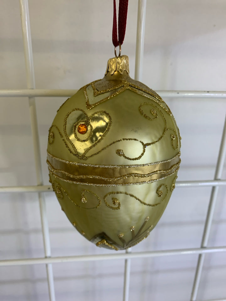 GOLD PINECONE GLASS ORNAMENT.