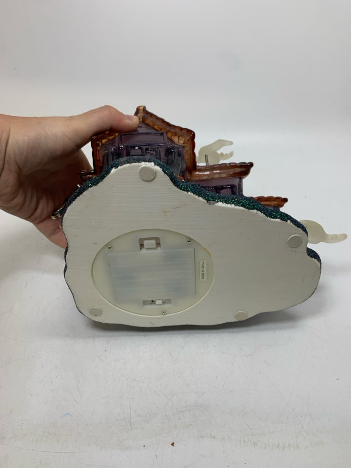 PLASTIC/RESIN PURPLE GHOST HAUNTED HOUSE W/ MUSIC/ FLSHING LIGHTS.