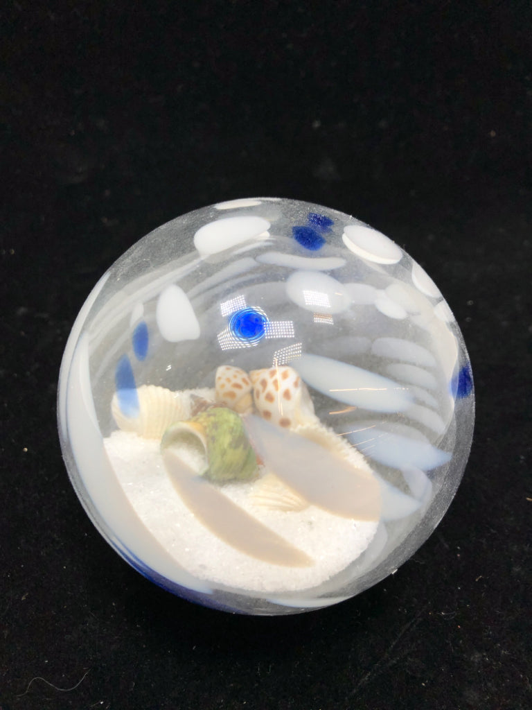 BLOWN GLASS BALL W/SAND AND SEASHELLS.