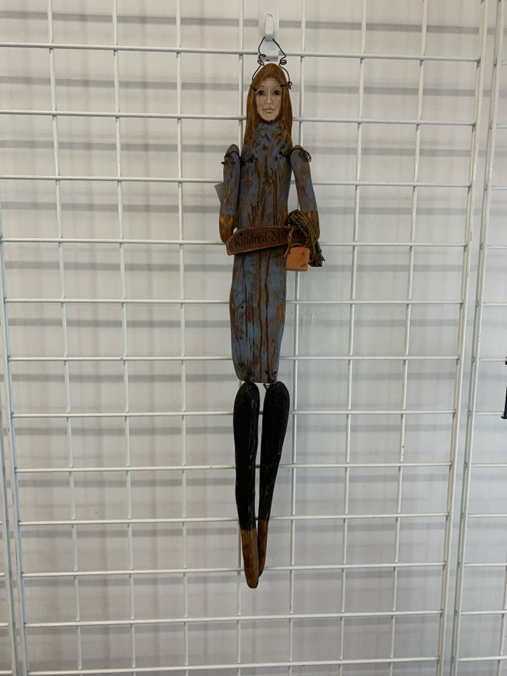 PRIMITIVE WOOD DOLL W WATERING CAN WALL HANGING.