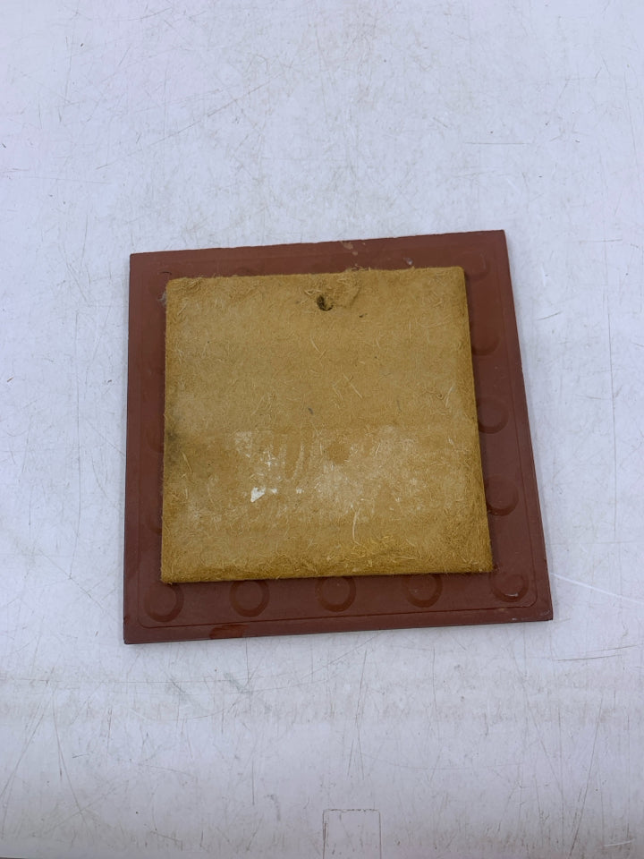 TERRA COTTA WOLF HOWLING AT THE MOON NEXT TO CACTUS.