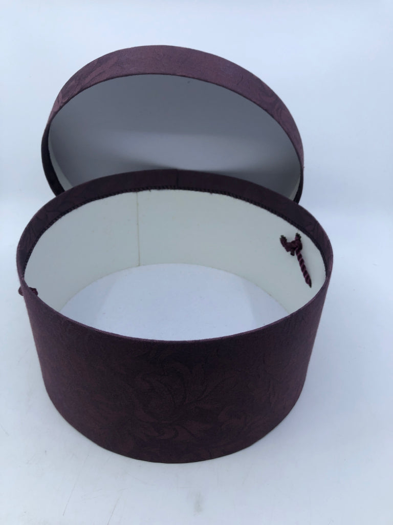 2 NESTING PURPLE FABRIC CIRCLE HAT BOXES.