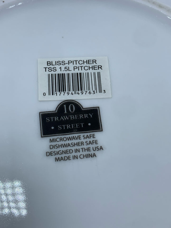 WHITE CERAMIC PITCHER.