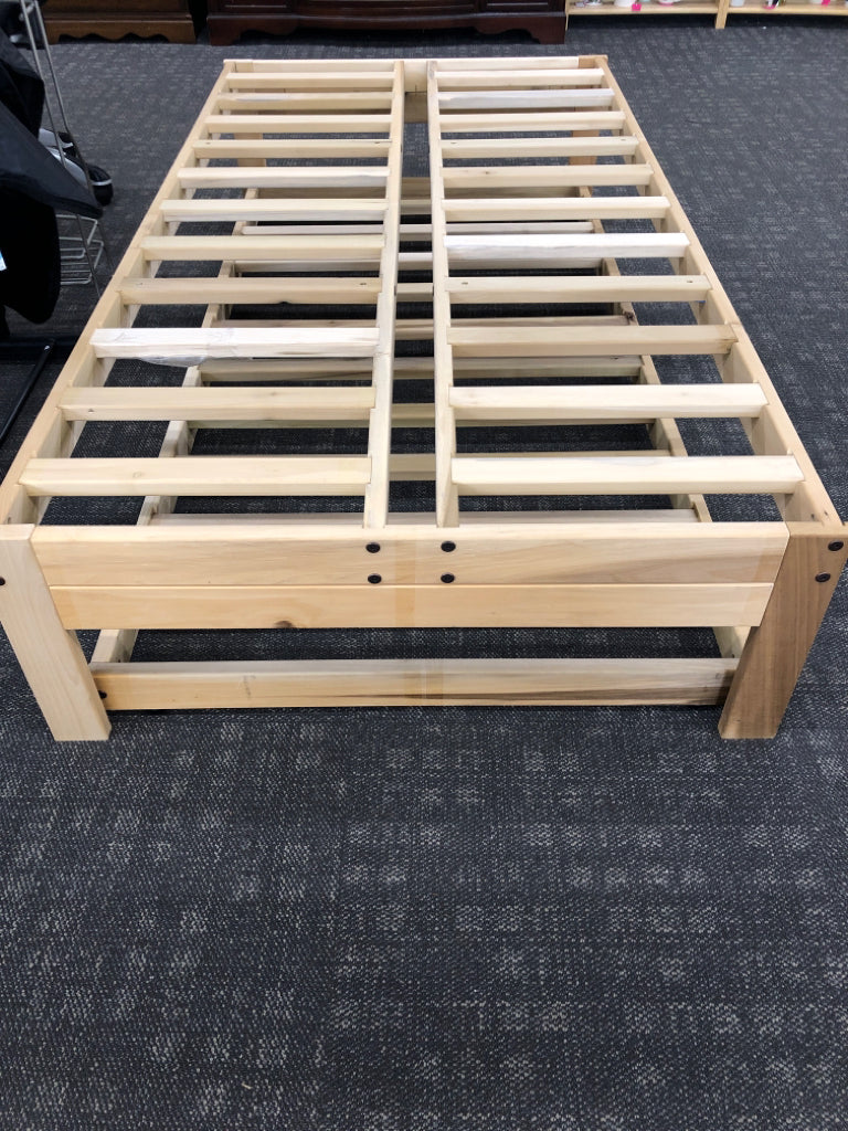 LIGHT WOOD TWIN PLATFORM WITH TRUNDLE BED.