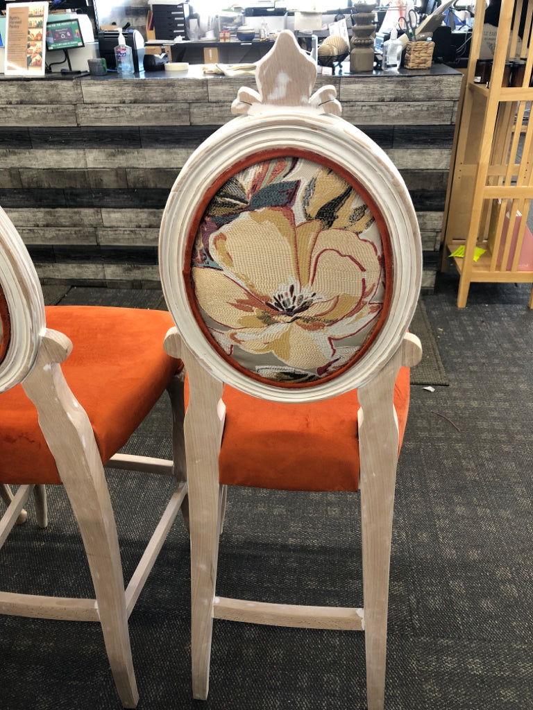 3 BURNT ORANGE UPHOLSTERED WHITE WASHED BAR STOOLS W/ FLORAL DESIGN ON BACK.
