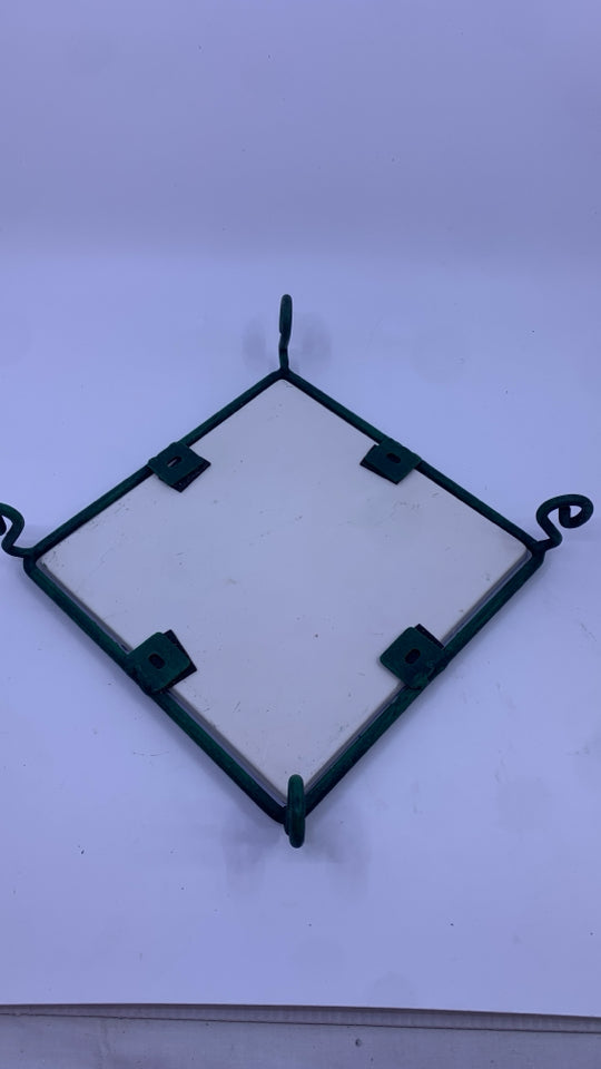FRUIT PAINTED CERAMIC TRIVET ON GREEN METAL STAND.
