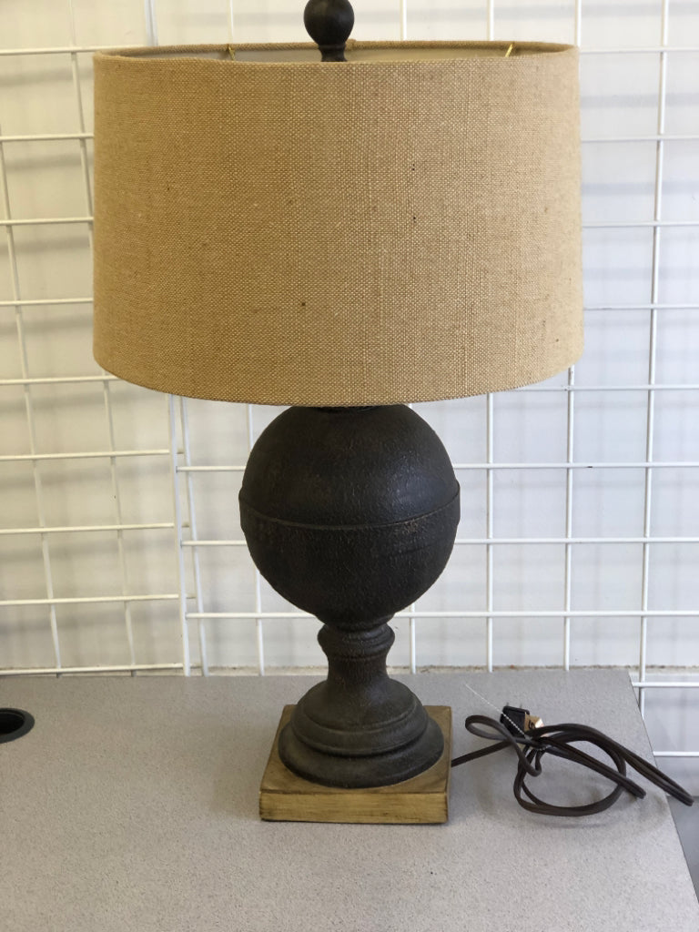 DARK BROWN TEXTURED BASE ON WOOD SLAB W/ BURLAP SHADE.