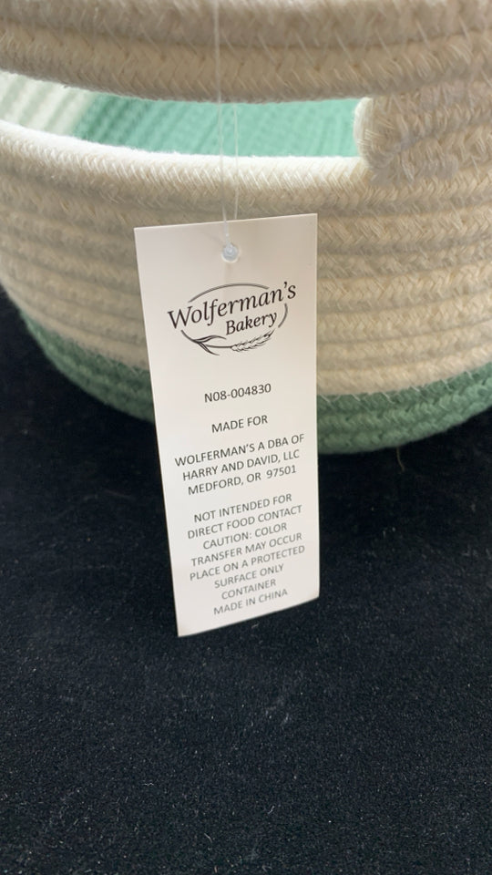 GREEN/WHITE WOVEN OVAL STORAGE BIN.